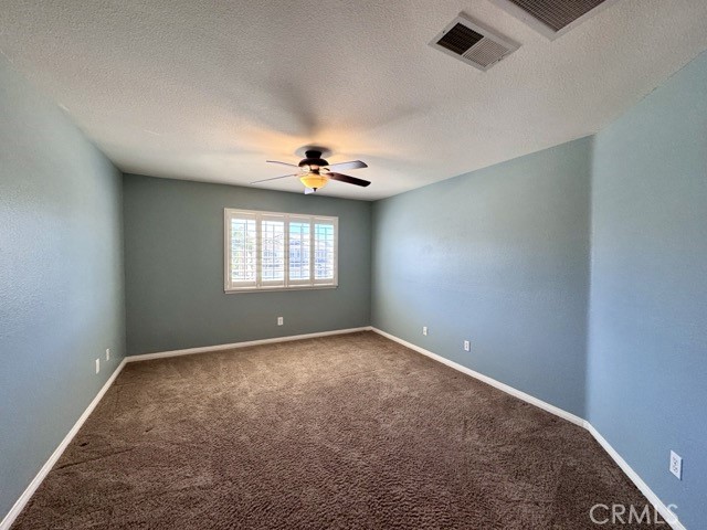 32948 Levi Court Temecula, CA 92592 - Photo 30 of 59 an empty room with windows and chandelier fan