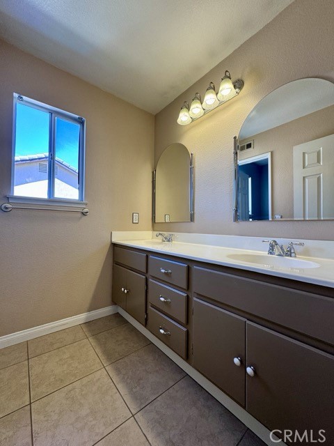 32948 Levi Court Temecula, CA 92592 - Photo 34 of 59 a spacious bathroom with a double vanity sink and a mirror