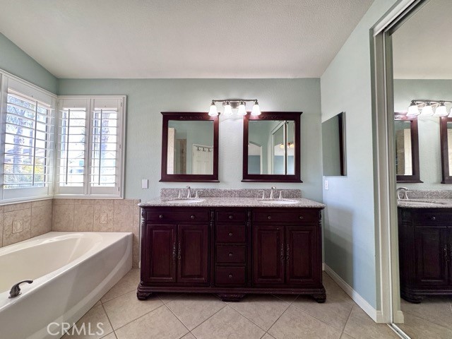 32948 Levi Court Temecula, CA 92592 - Photo 42 of 59 a bathroom with a tub sink and mirror