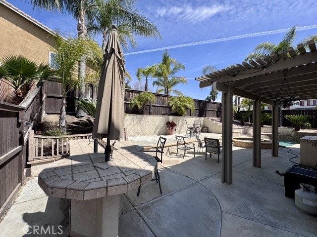 32948 Levi Court Temecula, CA 92592 - Photo 52 of 59 a view of a patio with dining table and chairs potted plants and palm tree