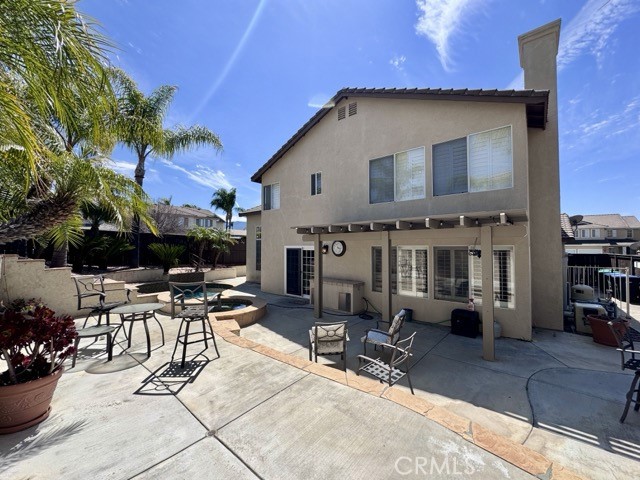 32948 Levi Court Temecula, CA 92592 - Photo 53 of 59 a view of a patio with table and chairs potted plants and a barbeque