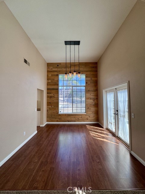 32948 Levi Court Temecula, CA 92592 - Photo 9 of 59 an empty room with wooden floor chandelier and windows