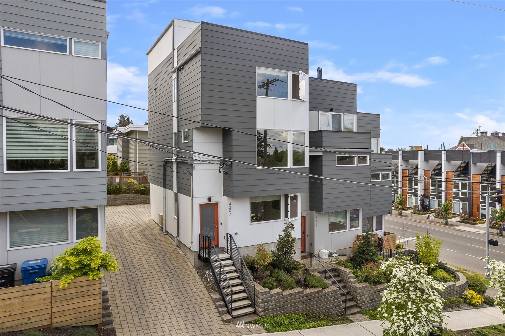 4207 Southwest Frontenac Street Seattle, WA 98136 - Photo 1 of 36 a front view of a house with a garden