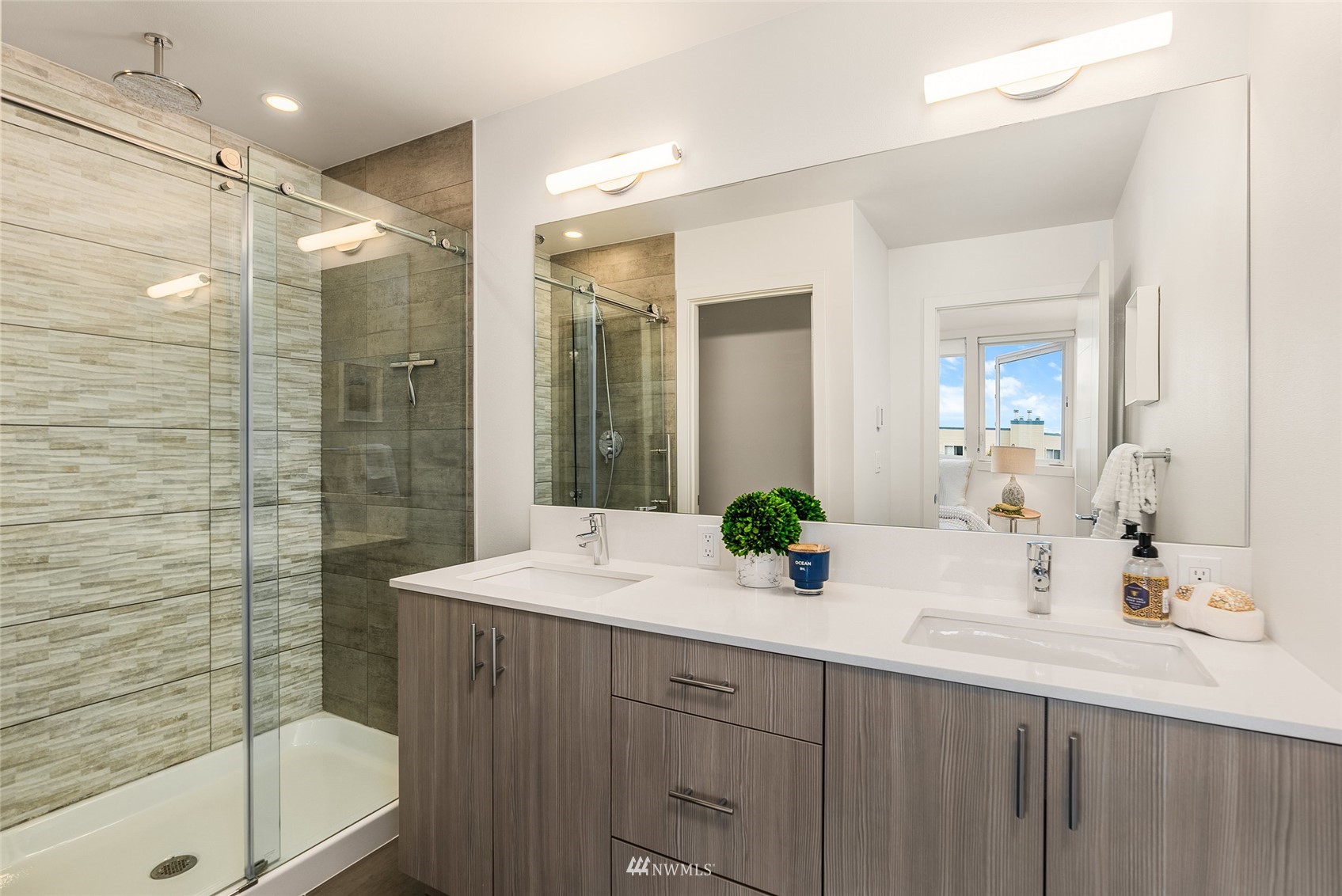 4207 Southwest Frontenac Street Seattle, WA 98136 - Photo 15 of 36 a bathroom with a double vanity sink mirror double and shower