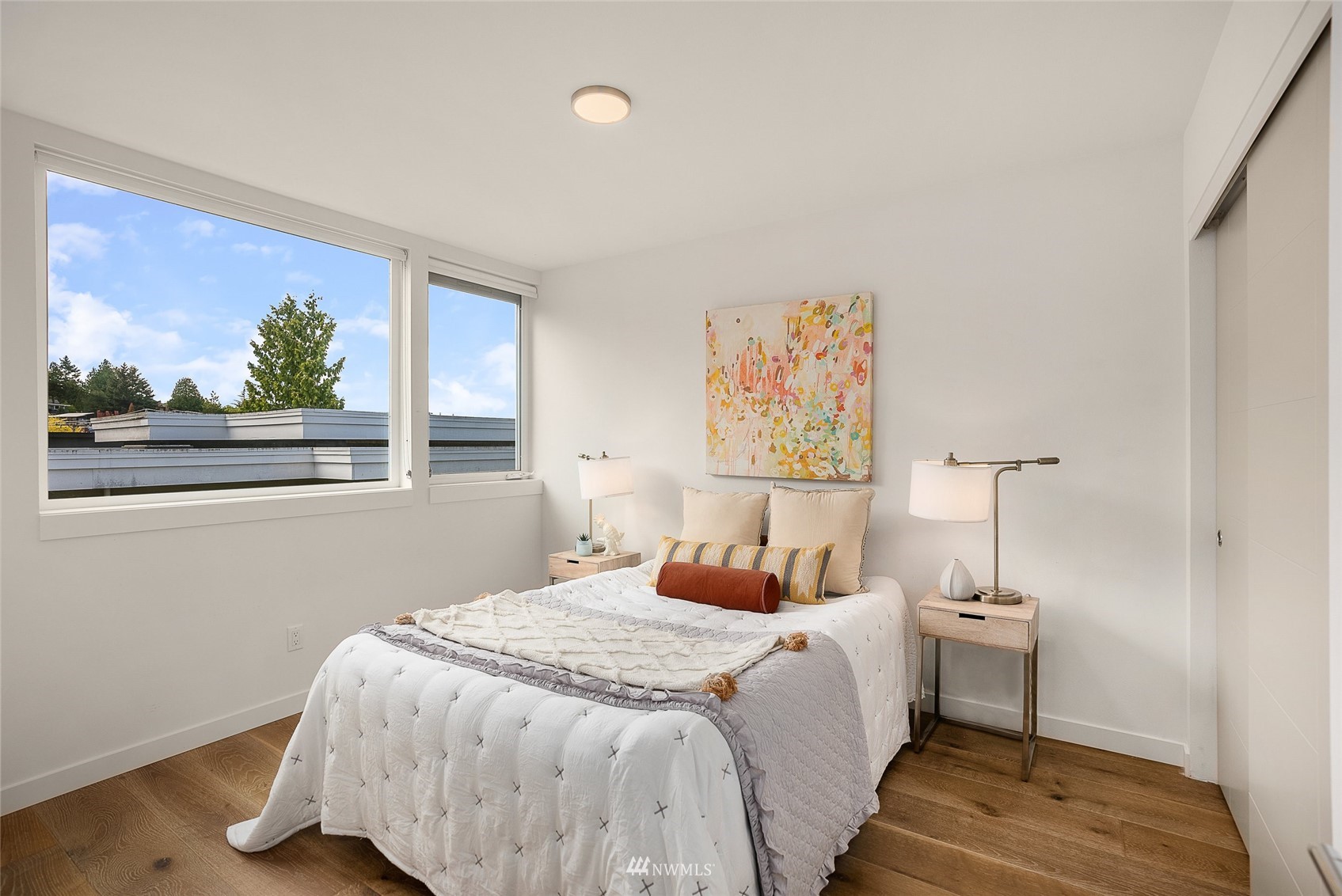 4207 Southwest Frontenac Street Seattle, WA 98136 - Photo 16 of 36 a bedroom with a bed and a painting on the wall