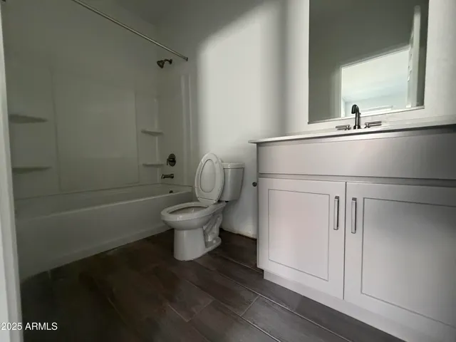 a white toilet sitting next to a bathroom sink