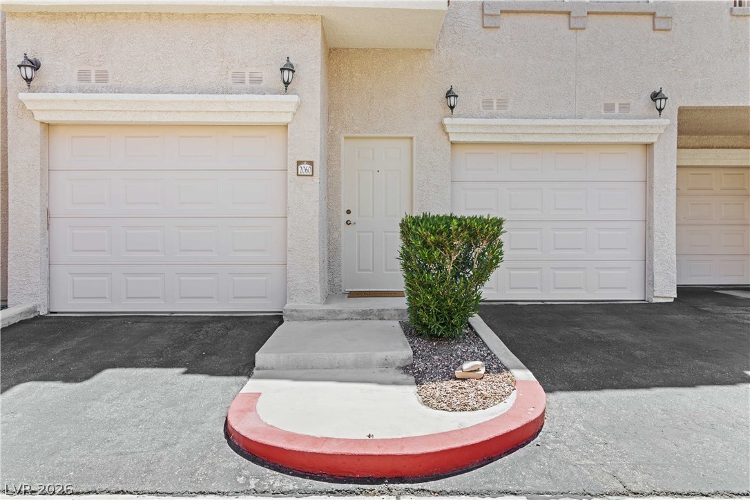 10550 West Alexander Road, Unit 2060 Las Vegas, NV 89129 - Photo 8 of 45 A welcoming entry, flanked by two convenient garages, offers easy access.