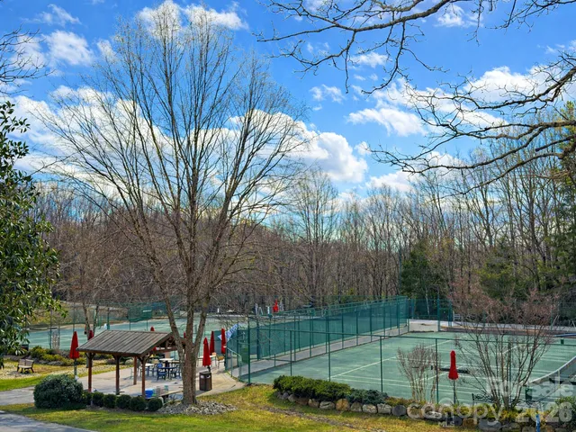 a view of a park with iron fence