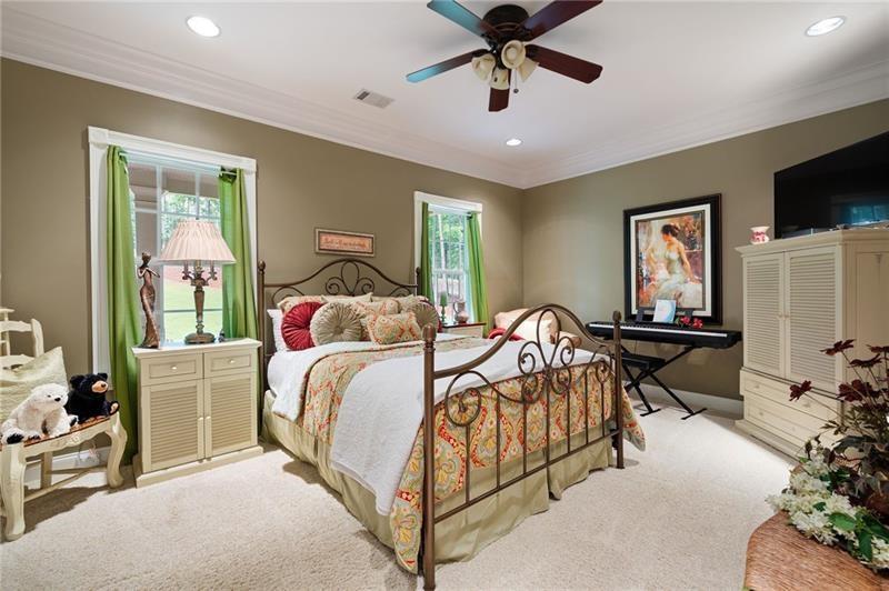 7131 Ridge Road Hiram, GA 30141 - Photo 25 of 63 a bedroom with a bed and a chandelier