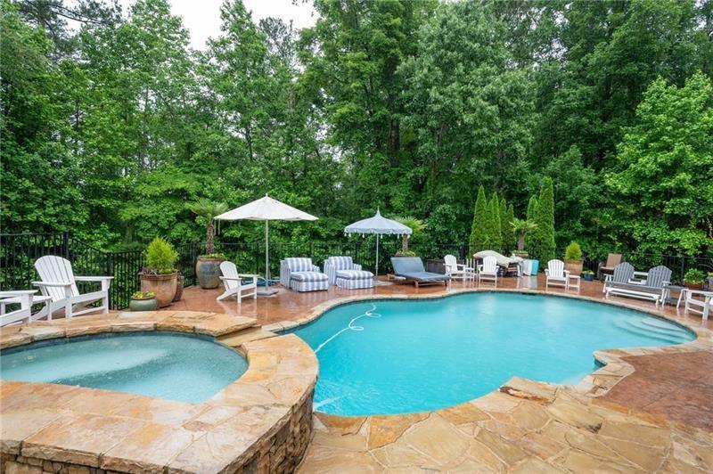 7131 Ridge Road Hiram, GA 30141 - Photo 3 of 63 a view of a swimming pool with lawn chairs under an umbrella