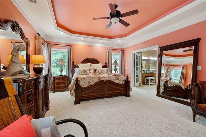 7131 Ridge Road Hiram, GA 30141 - Photo 31 of 63 a bedroom with a large bed and a chandelier