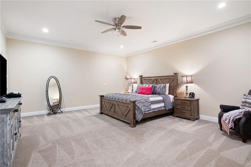 7131 Ridge Road Hiram, GA 30141 - Photo 45 of 63 a spacious bedroom with a bed and a chandelier