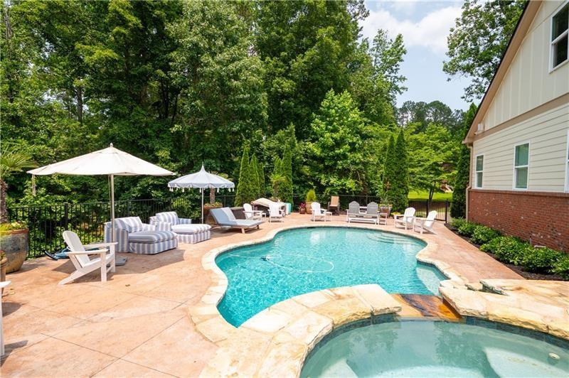 7131 Ridge Road Hiram, GA 30141 - Photo 53 of 63 a view of a swimming pool with a table and chairs under an umbrella