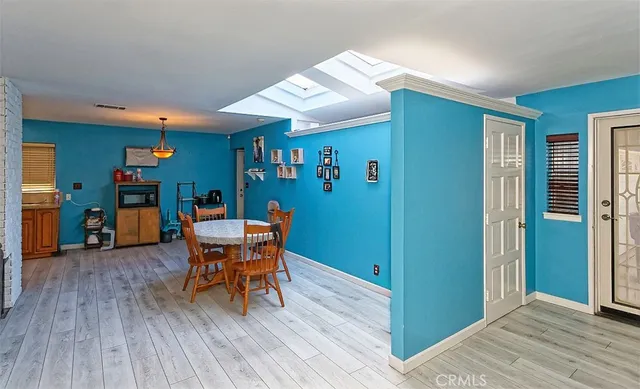 a dining room with furniture and wooden floor
