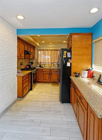 a kitchen with stainless steel appliances granite countertop a stove and refrigerator