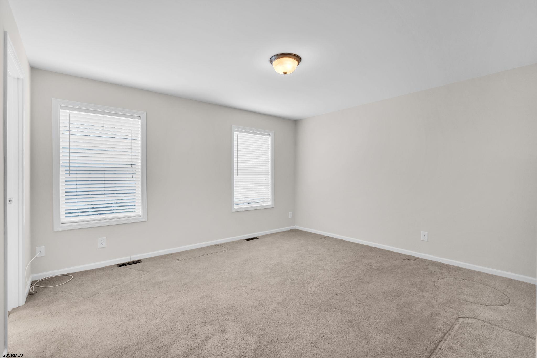 2058 South Shore Road, Unit 104 Marmora, NJ 08230 - Photo 11 of 20 an empty room with windows