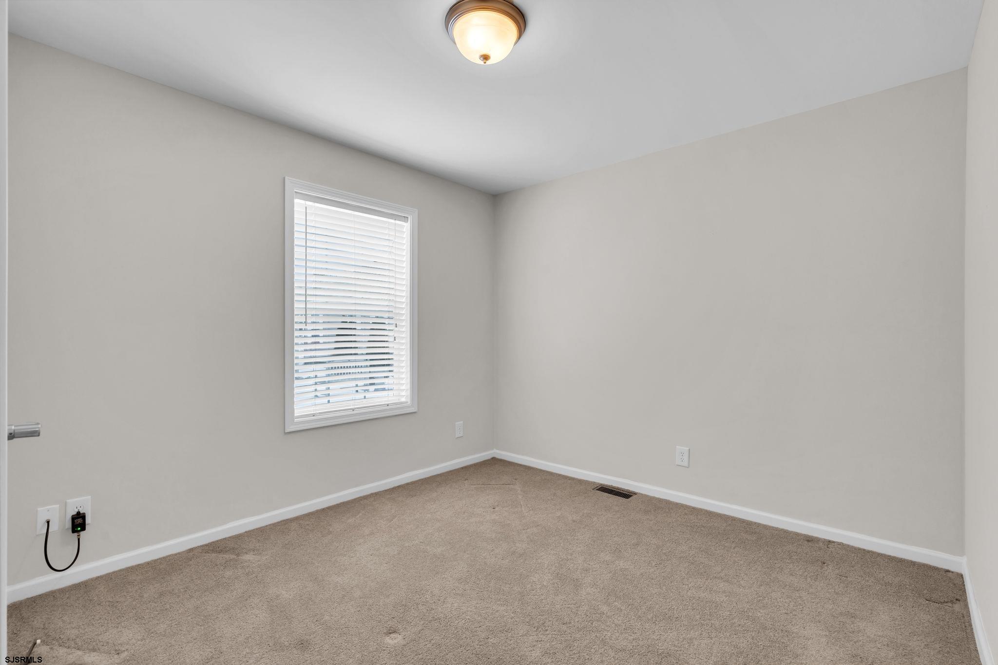 2058 South Shore Road, Unit 104 Marmora, NJ 08230 - Photo 13 of 20 an empty room with window and window