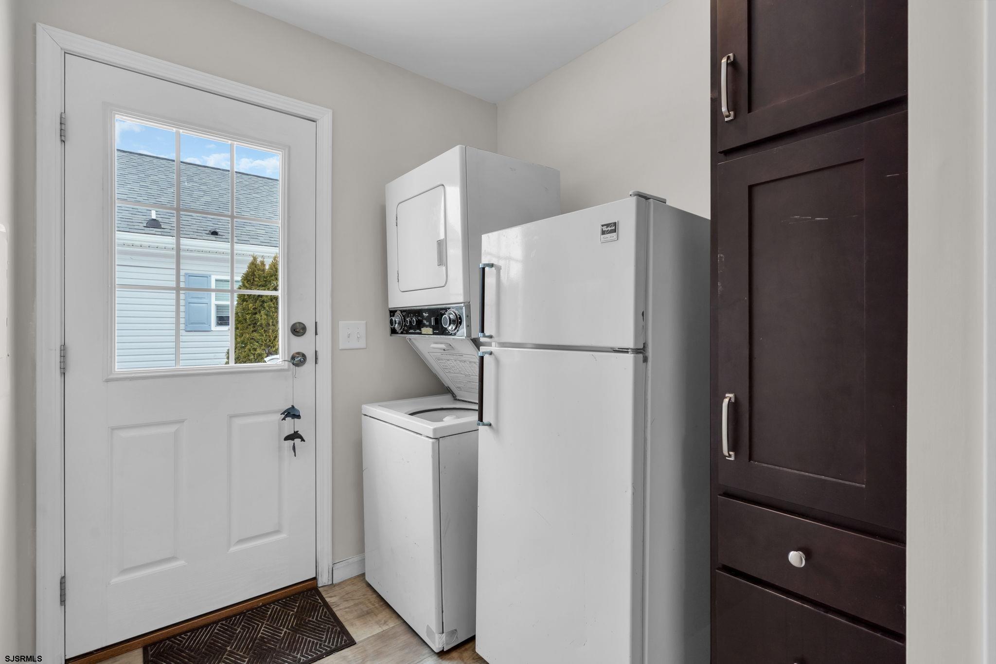 2058 South Shore Road, Unit 104 Marmora, NJ 08230 - Photo 14 of 20 a white refrigerator freezer and a dishwasher in a kitchen