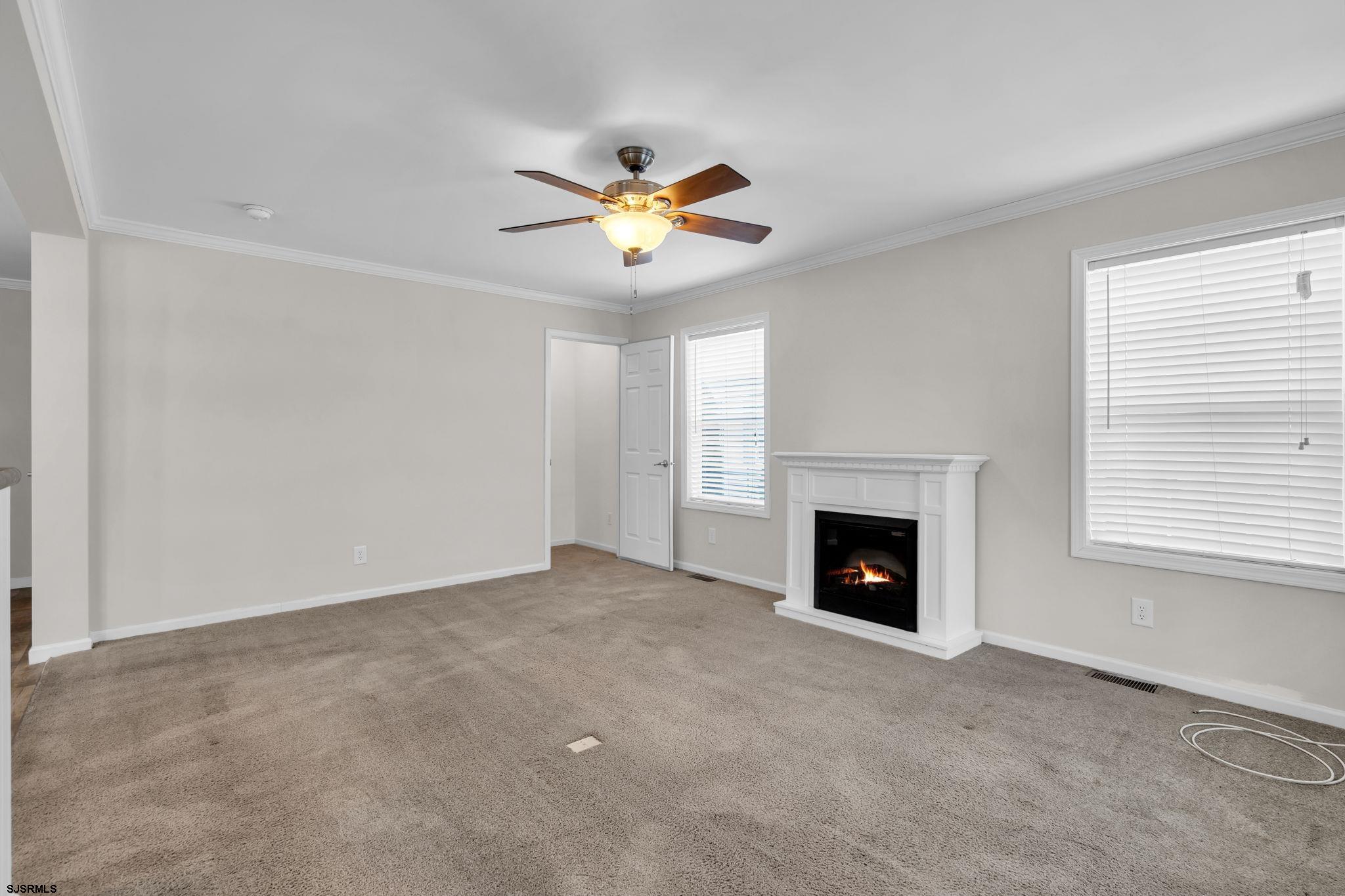 2058 South Shore Road, Unit 104 Marmora, NJ 08230 - Photo 3 of 20 a view of a livingroom with a fireplace and a window