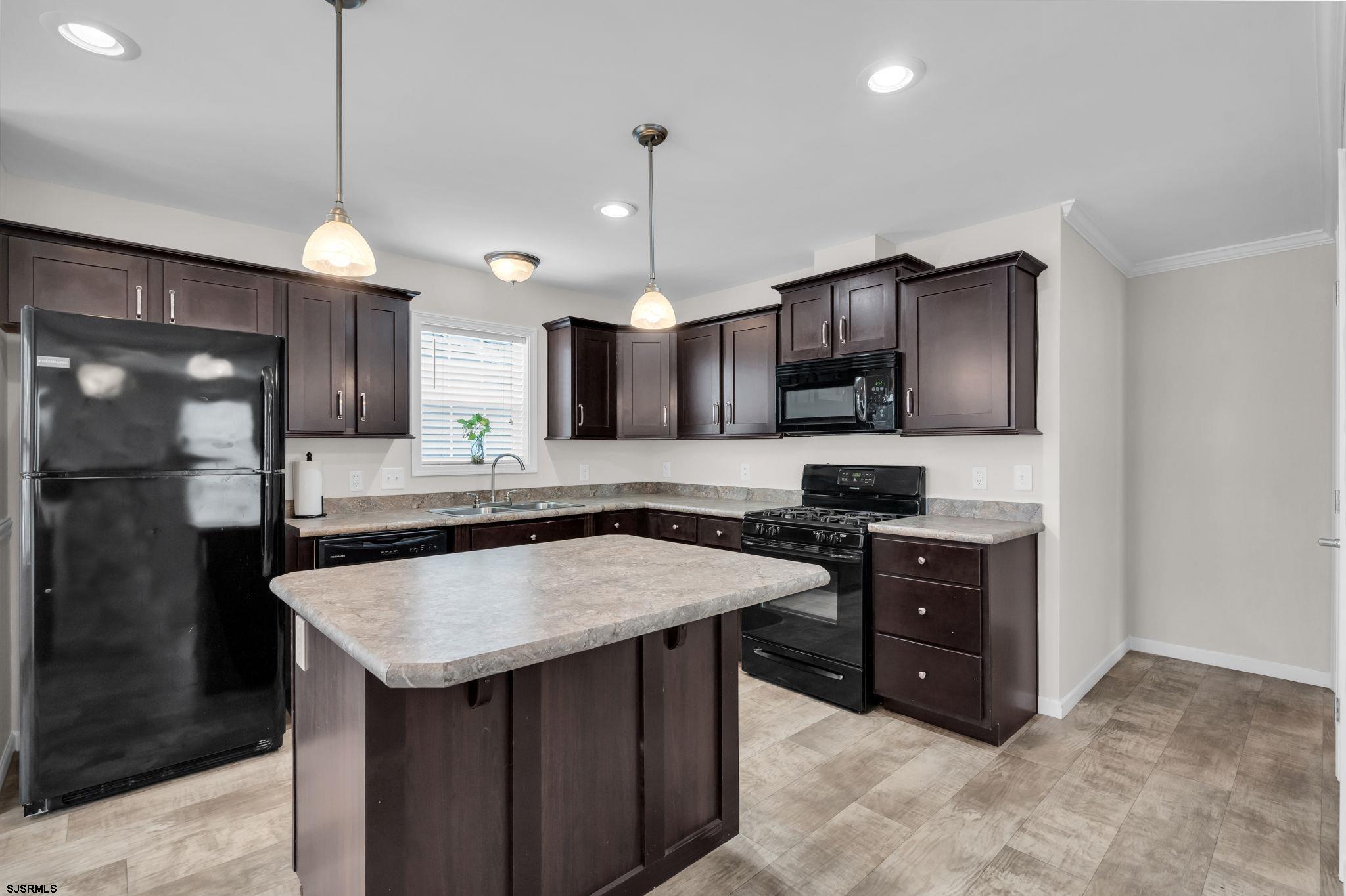 2058 South Shore Road, Unit 104 Marmora, NJ 08230 - Photo 4 of 20 a kitchen with stainless steel appliances granite countertop a sink stove and refrigerator