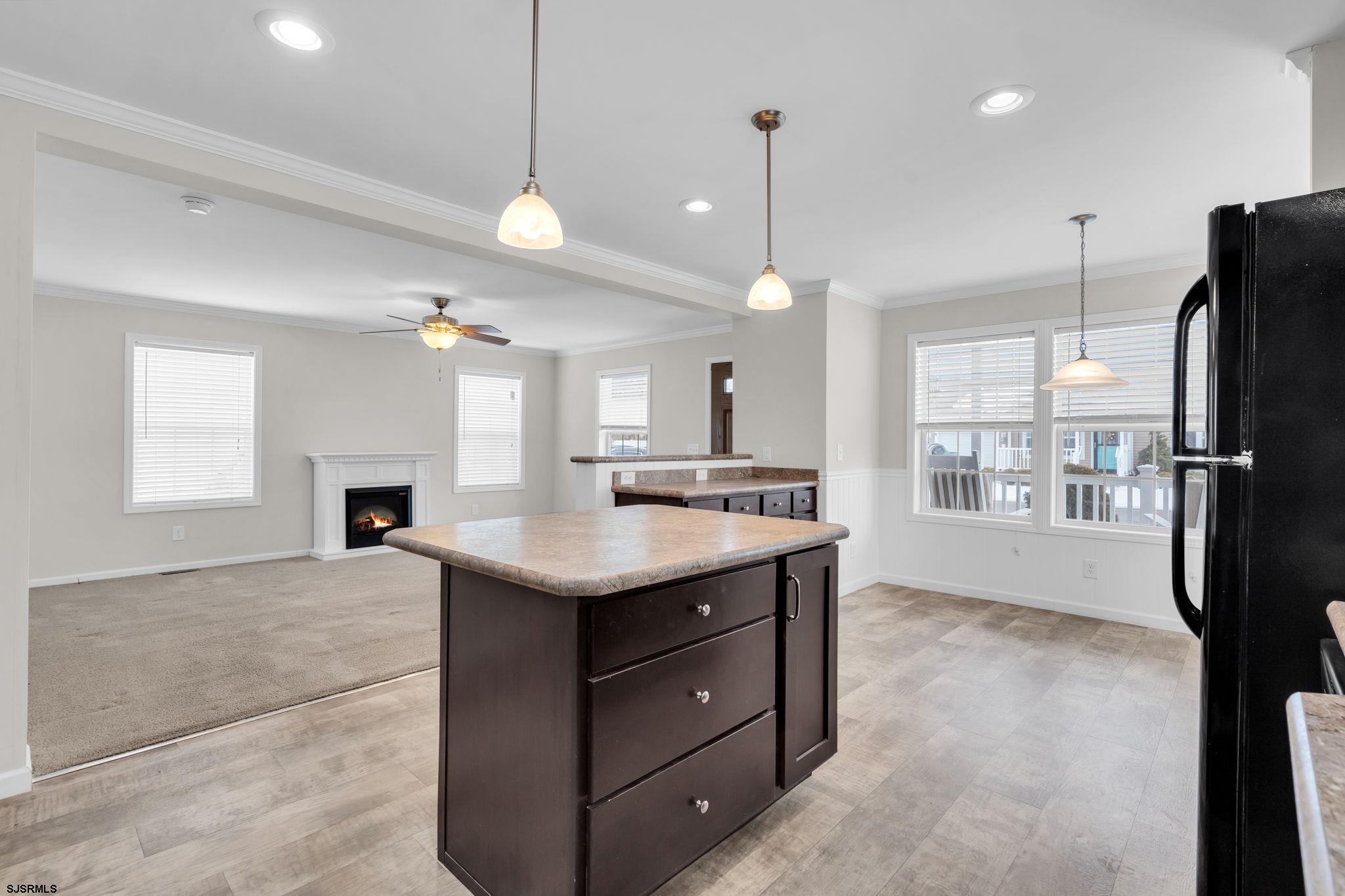 2058 South Shore Road, Unit 104 Marmora, NJ 08230 - Photo 6 of 20 a kitchen with a refrigerator a sink and a wooden floor
