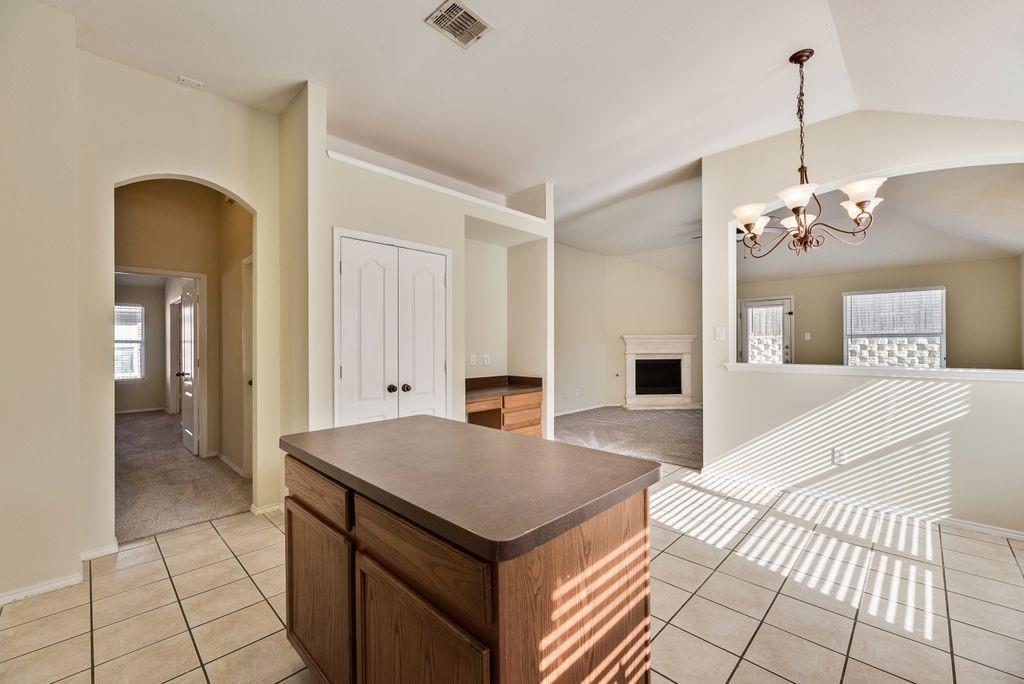 2721 Lone Ranger Trail Little Elm, TX 75068 - Photo 12 of 23 a living room with a table chairs and a chandelier