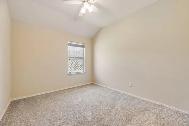an empty room with a fan
