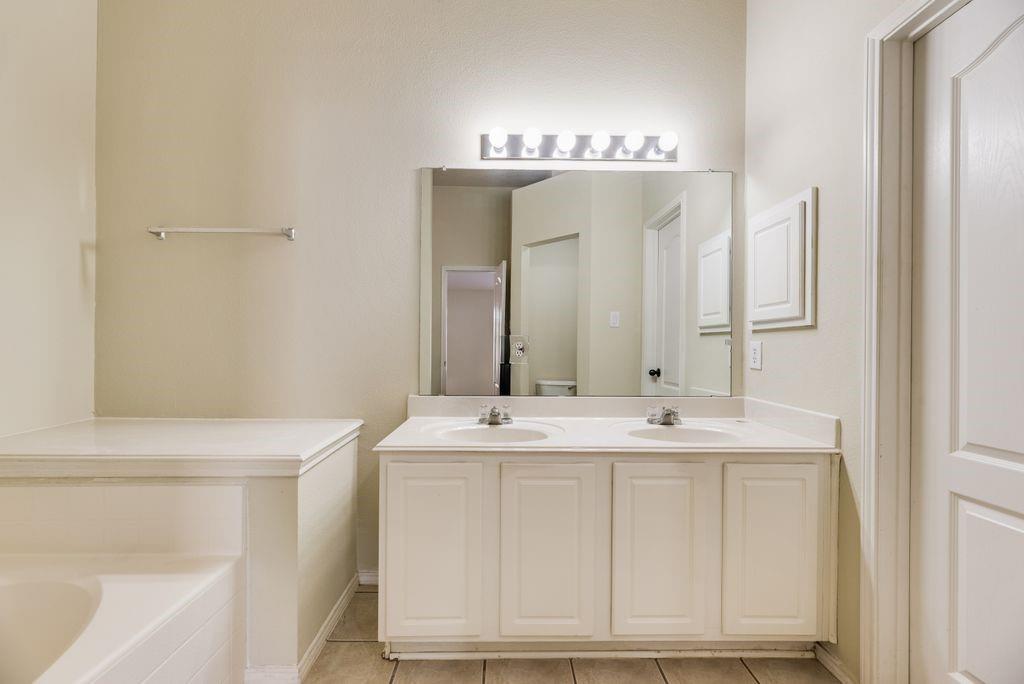 2721 Lone Ranger Trail Little Elm, TX 75068 - Photo 20 of 23 a bathroom with a sink and a mirror