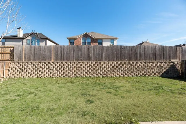 a wall with a trees in the background