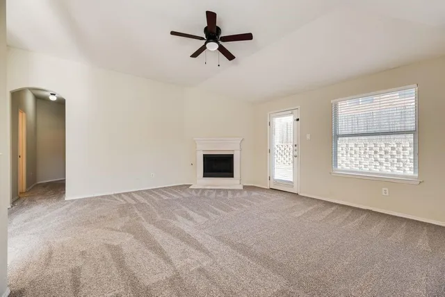 a view of empty room with ceiling fan
