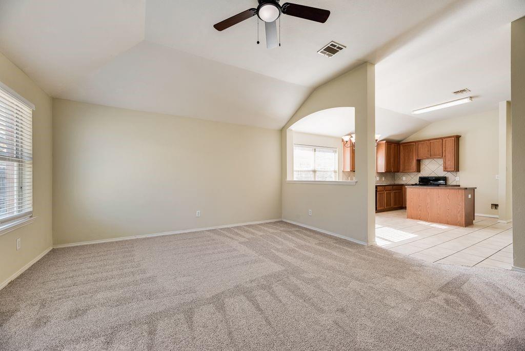 2721 Lone Ranger Trail Little Elm, TX 75068 - Photo 8 of 23 an empty room with windows and a kitchen view