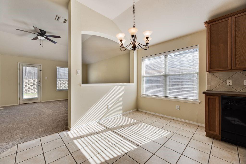 2721 Lone Ranger Trail Little Elm, TX 75068 - Photo 10 of 23 a view of an empty room with a fireplace and a window