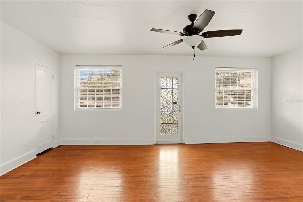 404 West Whidden Street Arcadia, FL 34266 - Photo 12 of 34 a view of an empty room with wooden floor and a window