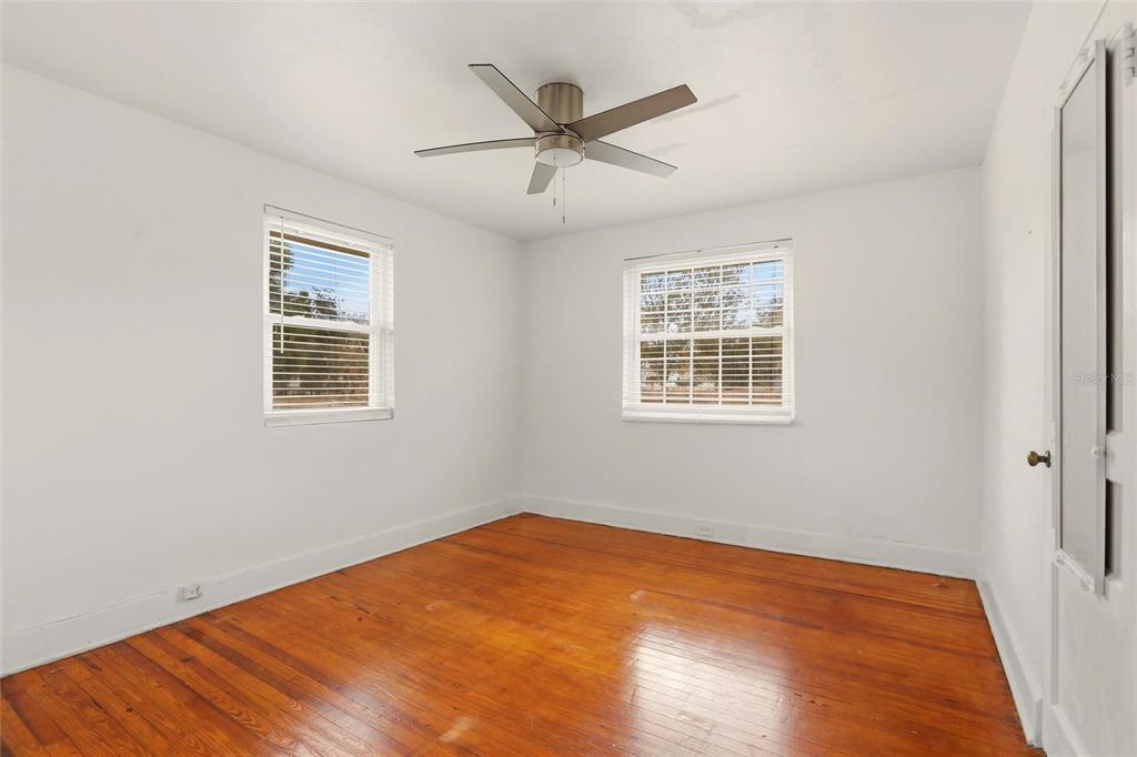 404 West Whidden Street Arcadia, FL 34266 - Photo 21 of 34 a view of a big room with wooden floor and windows