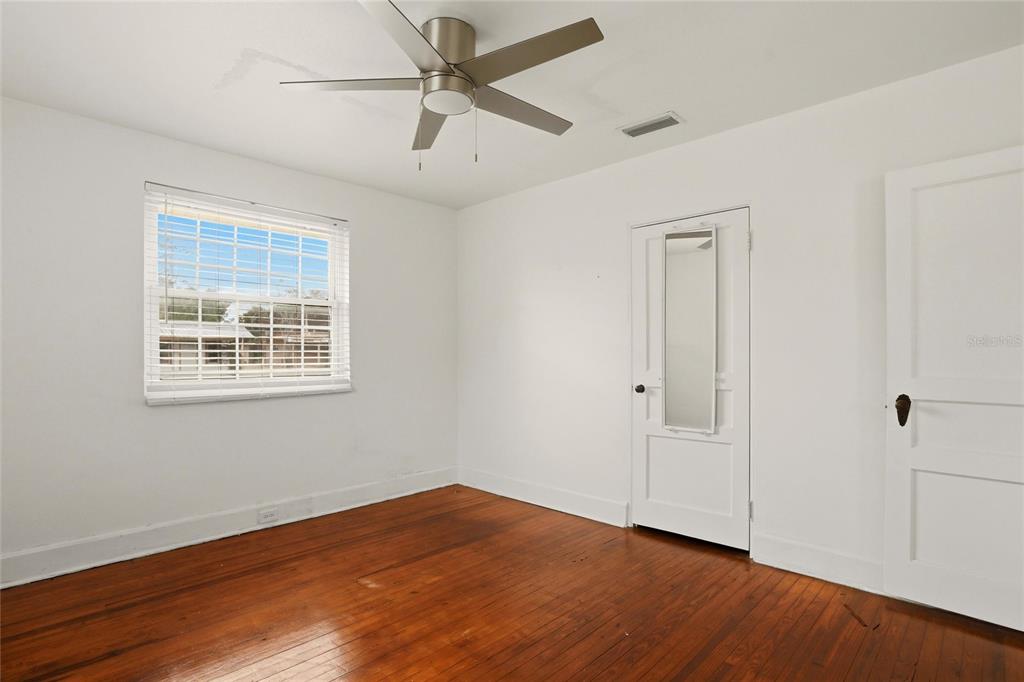 404 West Whidden Street Arcadia, FL 34266 - Photo 22 of 34 a view of an empty room with wooden floor and a window