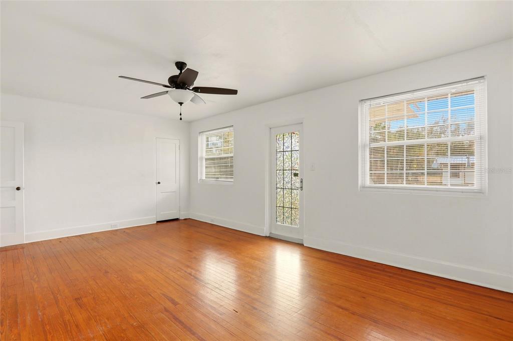 404 West Whidden Street Arcadia, FL 34266 - Photo 4 of 34 wooden floor in an empty room with a window