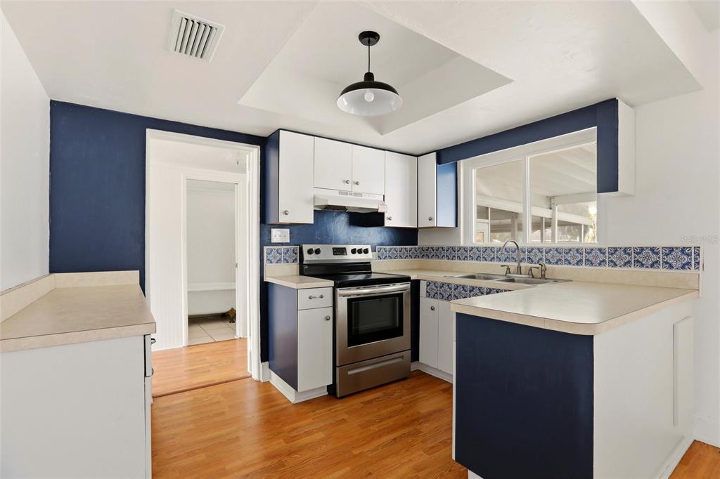 404 West Whidden Street Arcadia, FL 34266 - Photo 9 of 34 a kitchen with granite countertop a sink cabinets stainless steel appliances and a window