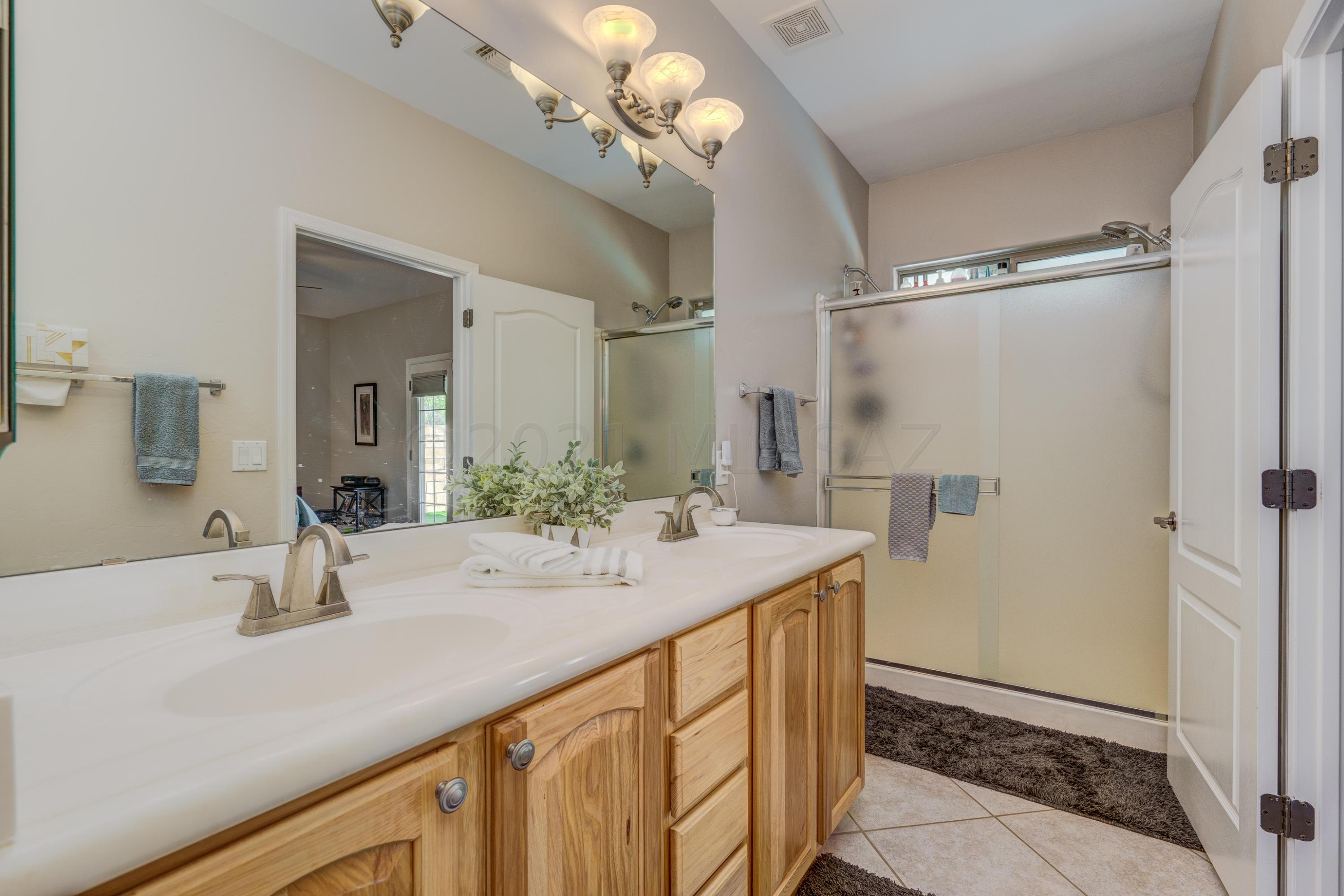 3639 East Northern Dancer Road Tucson, AZ 85739 - Photo 26 of 48 a bathroom with a sink tub and a mirror