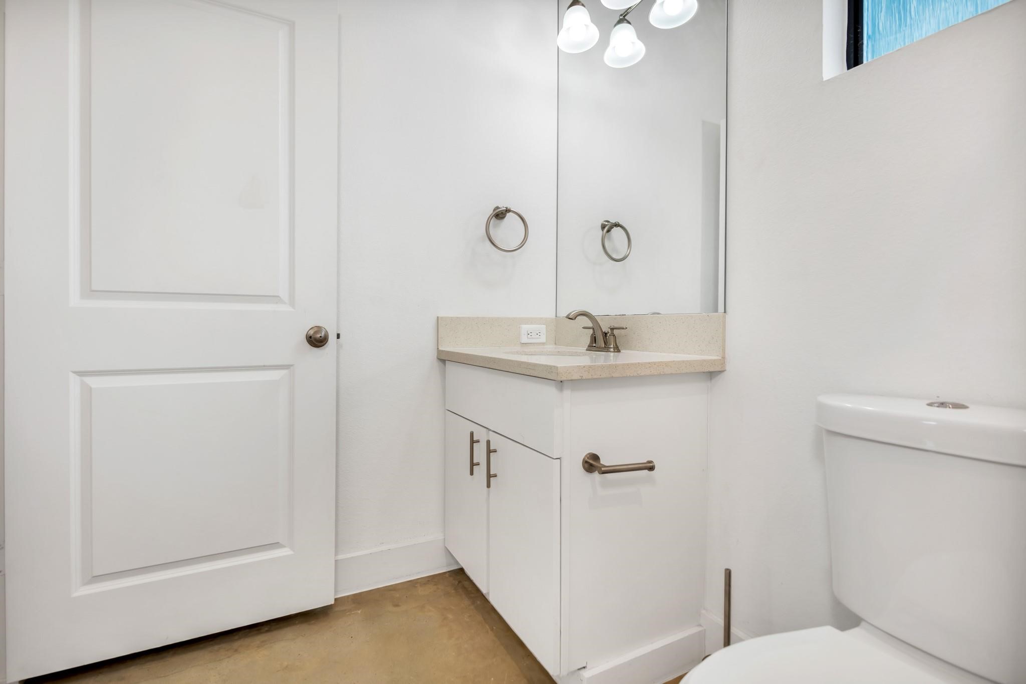 603 Edgewood Street, Unit B Houston, TX 77023 - Photo 10 of 16 Contemporary full bath features a bright white vanity, tiled shower-tub combo, and a privacy window for soft, natural light.