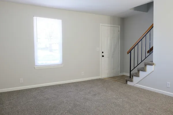 a view of an empty room with stairs