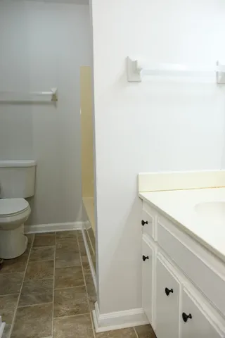 a bathroom with a toilet and a shower