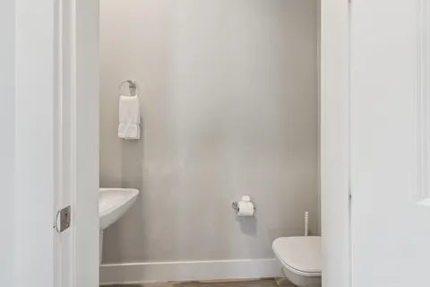 a bathroom with a toilet and a shower
