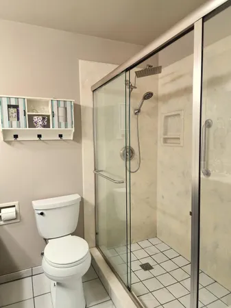 a bathroom with a toilet and a shower