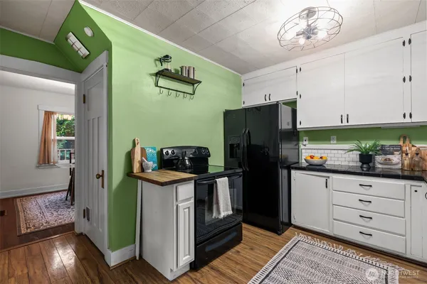 a kitchen with a refrigerator and a stove top oven