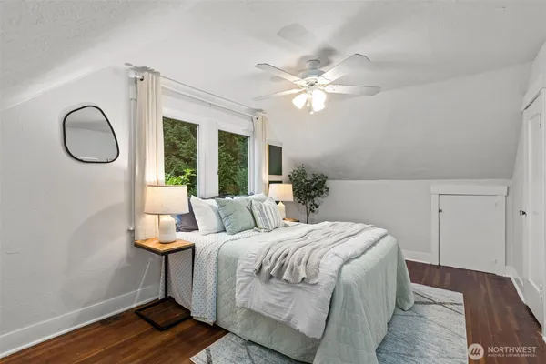 a bedroom with a large bed and a chandelier