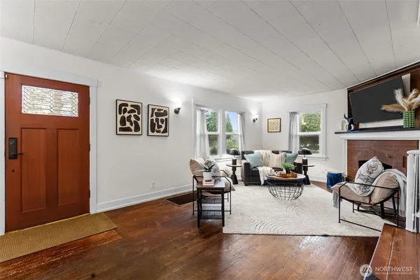 a living room with fireplace furniture and a flat screen tv
