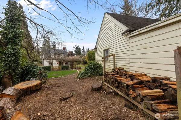 a view of a yard with wooden fence