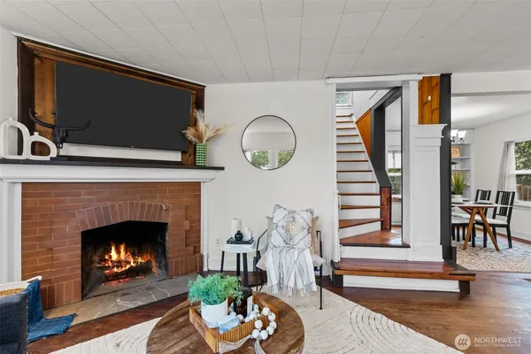 a living room with furniture a fireplace and a flat screen tv