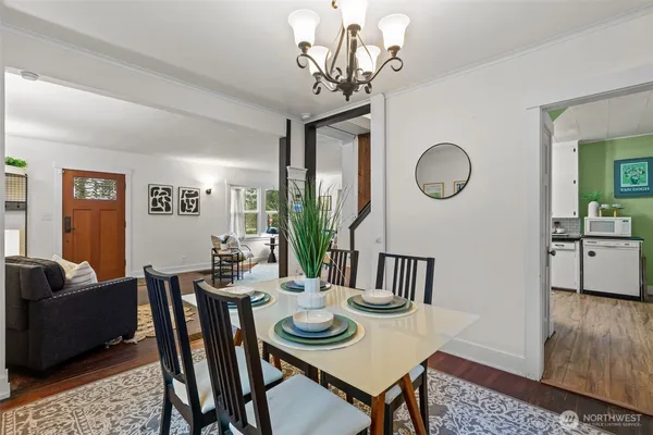 a view of a dining room with furniture and a chandelier