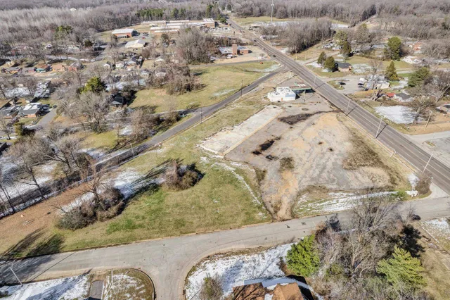 a view of a backyard with wooden fence